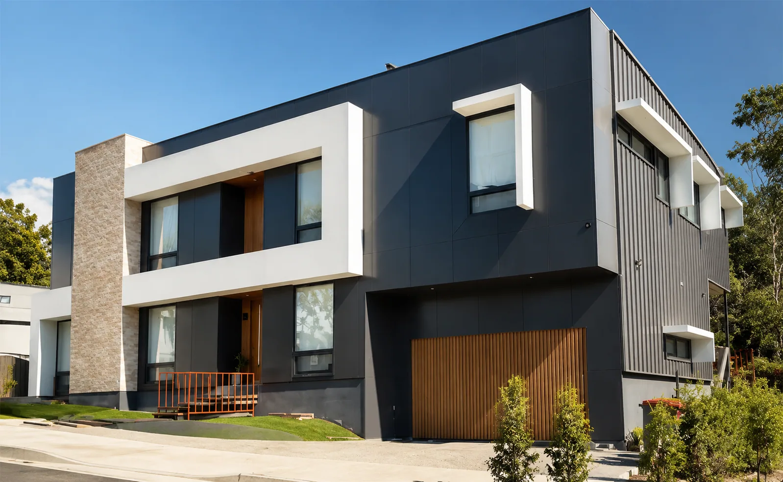 Living room with broad black aluminium windows framing a landscape